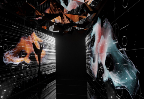 A futuristic and abstract art installation featuring geometric shapes, cosmic imagery, and dynamic light projections creating an immersive experience.