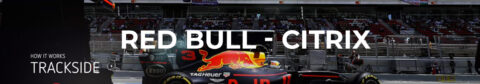 L'image présente une bannière avec une voiture de course Red Bull en arrière-plan, sur un circuit de course avec des gradins pleins de spectateurs. Au centre, le texte "RED BULL - CITRIX" est écrit en lettres blanches majuscules. À gauche, il y a un petit texte indiquant "HOW IT WORKS TRACKSIDE" avec une icône de lecture pour une vidéo.